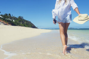 Woman walking on Florida beach after surgery